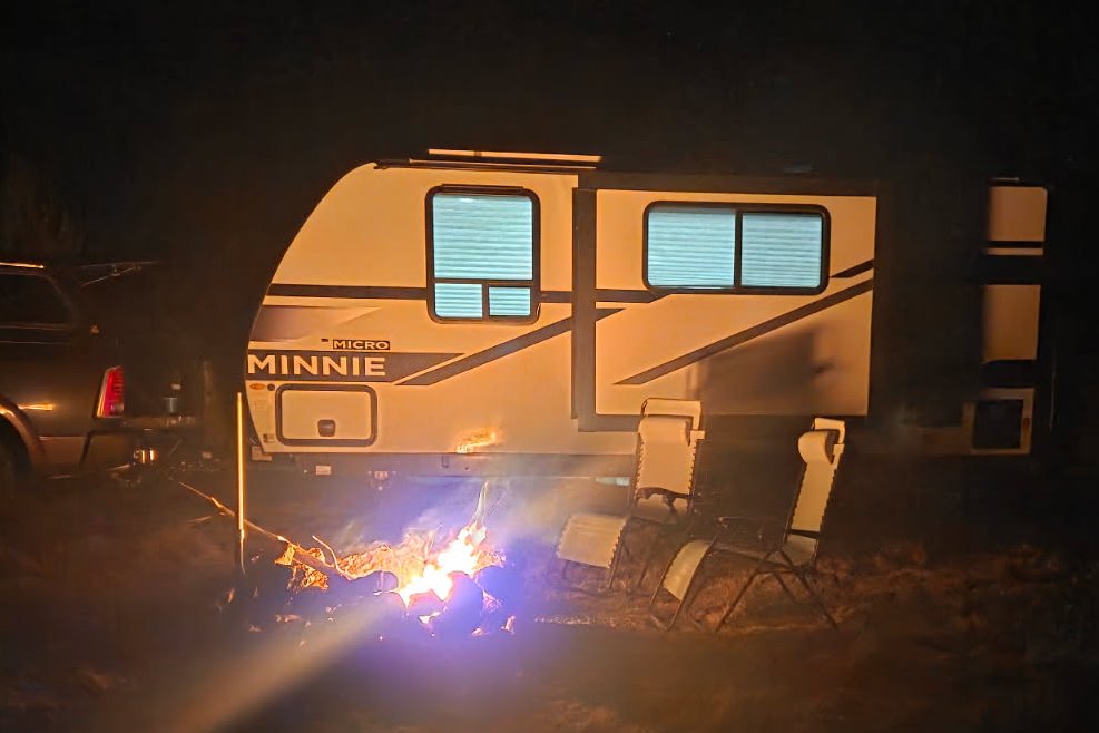 Campers enjoying a fire in the camping loop